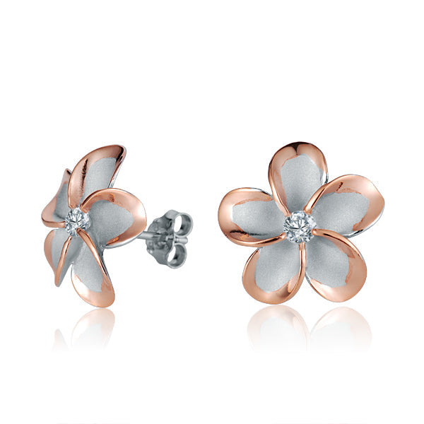 The photo show rose gold vermeil sterling silver rhodium plated plumeria stud earrings with cubic zirconia gems.