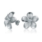 The photo show white gold vermeil sterling silver rhodium plated plumeria stud earrings with cubic zirconia gems.