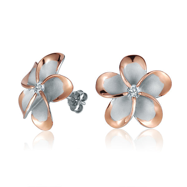 The photo show rose gold vermeil sterling silver rhodium plated plumeria stud earrings with cubic zirconia gems.