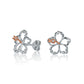 The photo is a pair of sterling silver hibiscus stud earrings with rose gold vermeil details. 