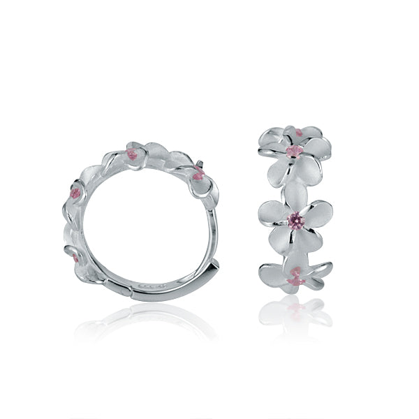 The photo show sterling silver plumeria hoop earrings with pink cubic zirconia gems.
