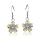 The photo show two-tone yellow and white sterling silver rhodium plated plumeria hook earrings with cubic zirconia stones. 
