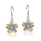 The photo show two-tone yellow and white sterling silver rhodium plated plumeria hook earrings with cubic zirconia stones. 