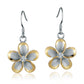 The photo show large two-tone yellow and white sterling silver rhodium plated plumeria hook earrings with cubic zirconia stones. 
