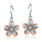 The photo show big two-tone rose and white sterling silver rhodium plated plumeria hook earrings with cubic zirconia stones. 