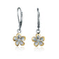 The photo shows a medium size two-tone yellow gold vermeil and sterling silver rhodium plated plumeria flower lever back earrings with cubic zirconia stones.