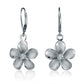 The photo shows a large size two-tone white gold vermeil and sterling silver rhodium plated plumeria flower lever back earrings with cubic zirconia stones.