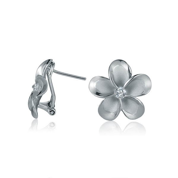 The photo shows a pair of white gold vermeil and sterling silver rhodium plated plumeria clip earrings with cubic zirconia. 