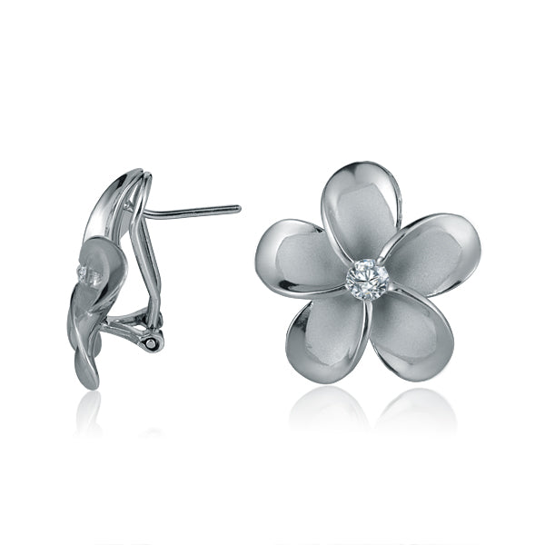 The photo shows a medium size pair of white gold vermeil and sterling silver rhodium plated flower clip earrings with cubic zirconia stones. 
