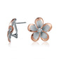 The photo shows a large size of rose gold vermeil and sterling silver rhodium plated plumeria clip earrings with cubic zirconia. 