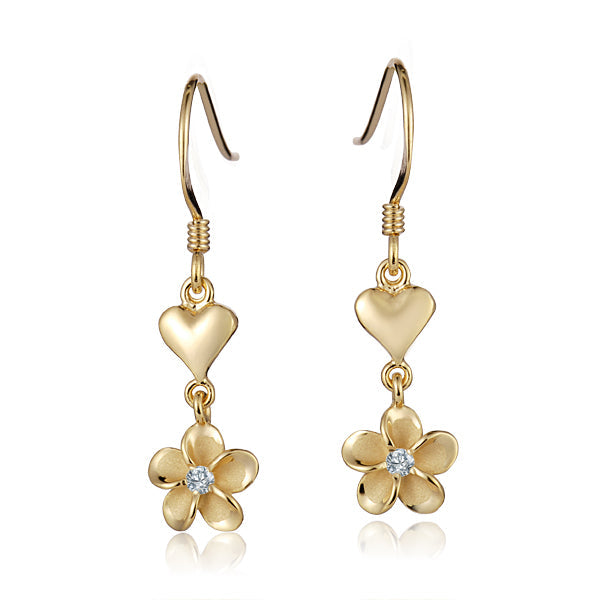 The photo shows a pair of yellow gold vermeil heart hook earrings featuring a plumeria design with cubic zirconia. 