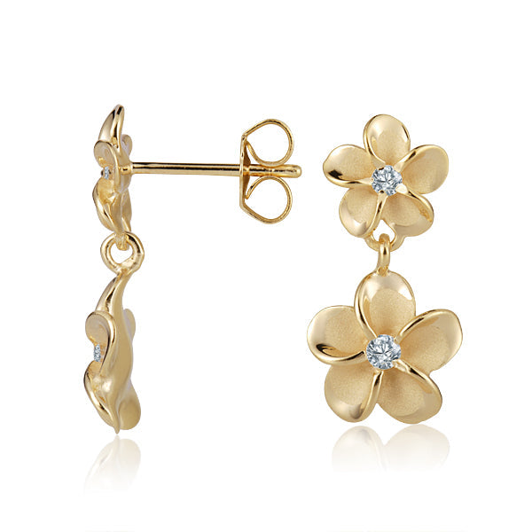 The photo shows a pair of yellow gold vermeil plumeria earrings with cubic zirconia the center. 