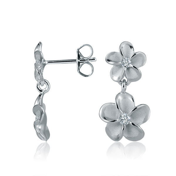 The photo shows a pair of white gold vermeil plumeria earrings with with cubic zirconia in the center. 