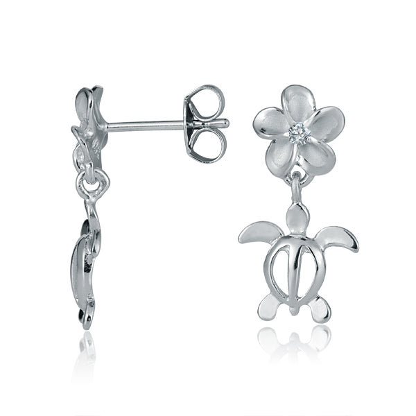 In the picture there are two white gold vermeil flower stud earrings featuring a sea turtle motif and cubic zirconia.