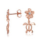In the picture you can see a pair of rose gold vermeil plumeria stud earrings featuring a sea turtle motif and a cubic zirconia stone.