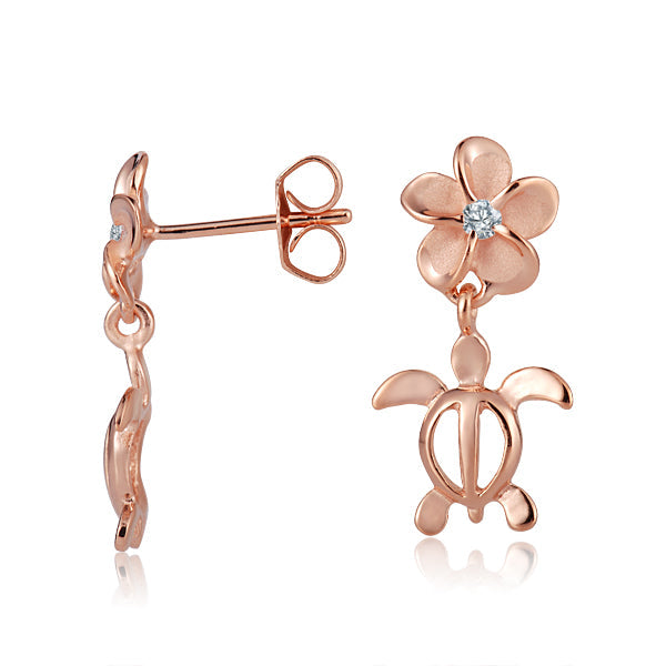 In the picture you can see a pair of rose gold vermeil plumeria stud earrings featuring a sea turtle motif and a cubic zirconia stone.