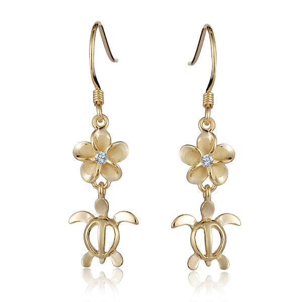 The photo shows a pair of yellow gold vermeil plumeria and sea turtle hook earrings with cubic zirconia.