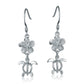 The photo shows a pair of white gold vermeil plumeria and sea turtle hook earrings with cubic zirconia.