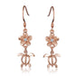 The photo shows an 8 mm pair of rose gold vermeil plumeria and sea turtle hook earrings with cubic zirconia.