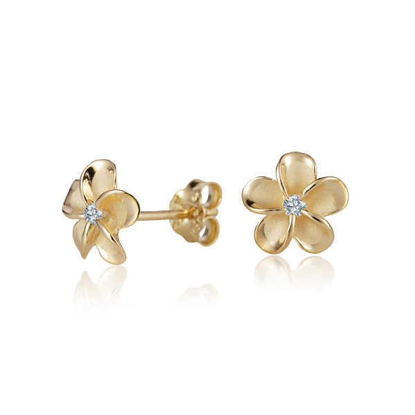 The photo shows a pair of yellow gold vermeil flower stud earrings with cubic zirconia. 