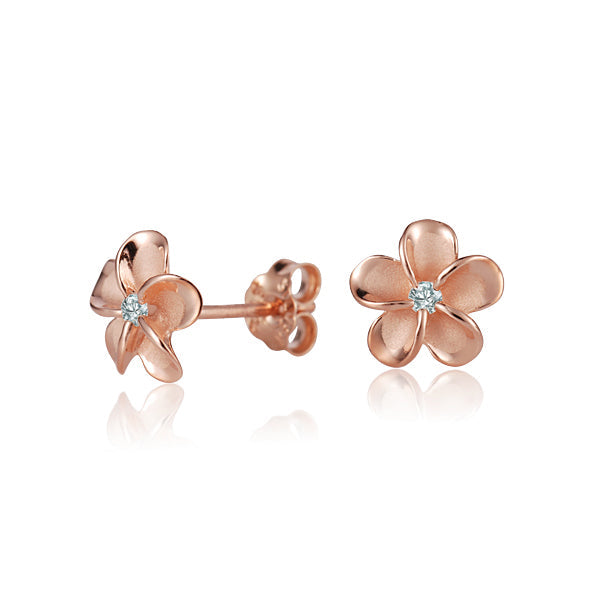 The photo shows a pair of rose gold vermeil flower stud earrings with cubic zirconia. 