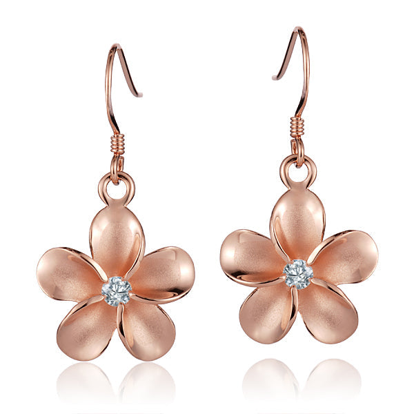 The picture shows a pair of rose gold vermeil plumeria hook earrings with cubic zirconia gems.