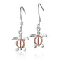 The picture has a pair of two-tone white and rose gold vermeil sea turtle hook earrings. 