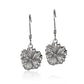 The picture shows a pair of white gold vermeil hibiscus hook earrings. 