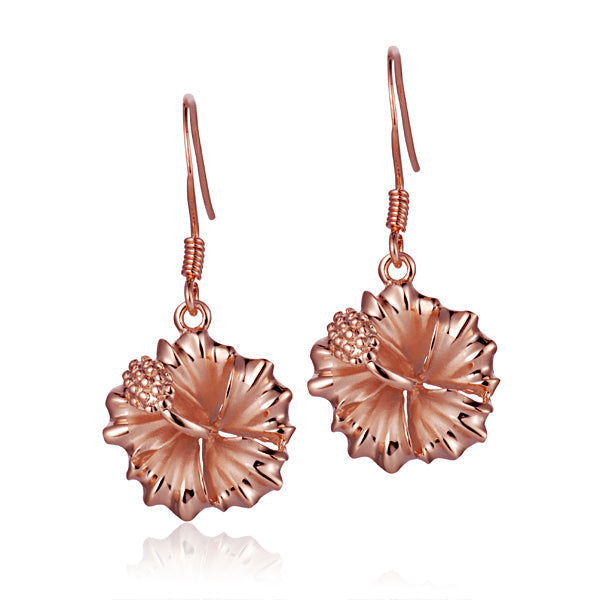 The photo shows a pair of rose gold vermeil hibiscus hook earrings. 
