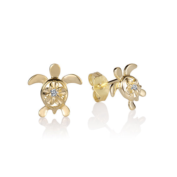 The photo shows a yellow gold vermeil pair of sea turtle stud earrings featuring a plumeria motif with cubic zirconia. 