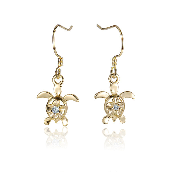 The photo shows a pair of yellow gold vermeil hook earrings featuring a plumeria motif with cubic zirconia. 