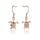 The photo shows a pair of rose gold vermeil hook earrings featuring a plumeria motif with cubic zirconia. 
